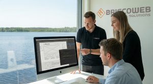 BriscoWeb design team collaborating on a custom website in Mooresville office overlooking Lake Norman